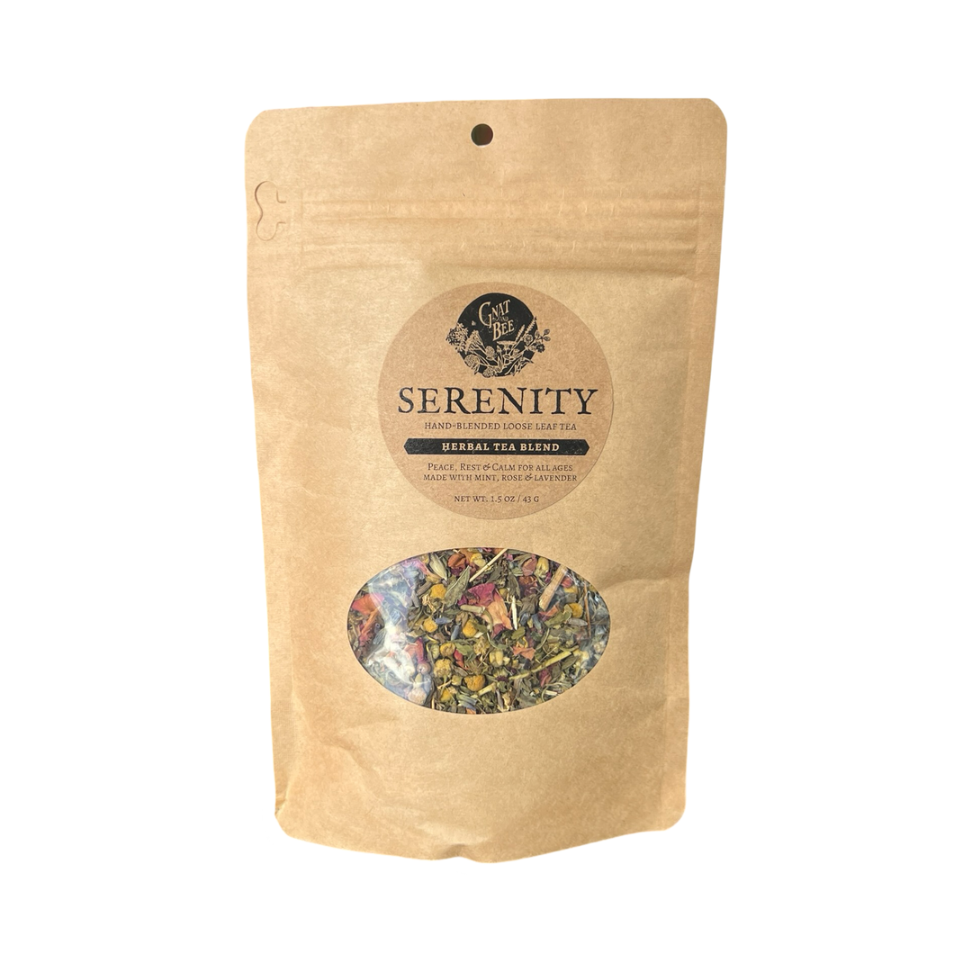 2 oz kraft pouch of Serenty tea with a branded label and a clear window that displays the dried herbs and flowers that makes the tea.