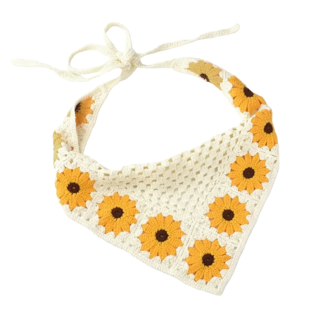 Cream crocheted triangle hair scarf with yellow sunflower granny squares and tie straps.