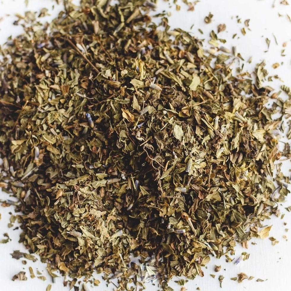 Loose herbal tea blend with dried mint leaves and lavender buds.