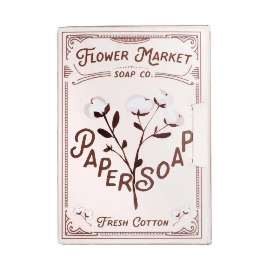 A white vintage style book package of Fresh Cotton paper soap leaves by Flower Market Soap Co., featuring illustrated cotton flower branches on the cover.