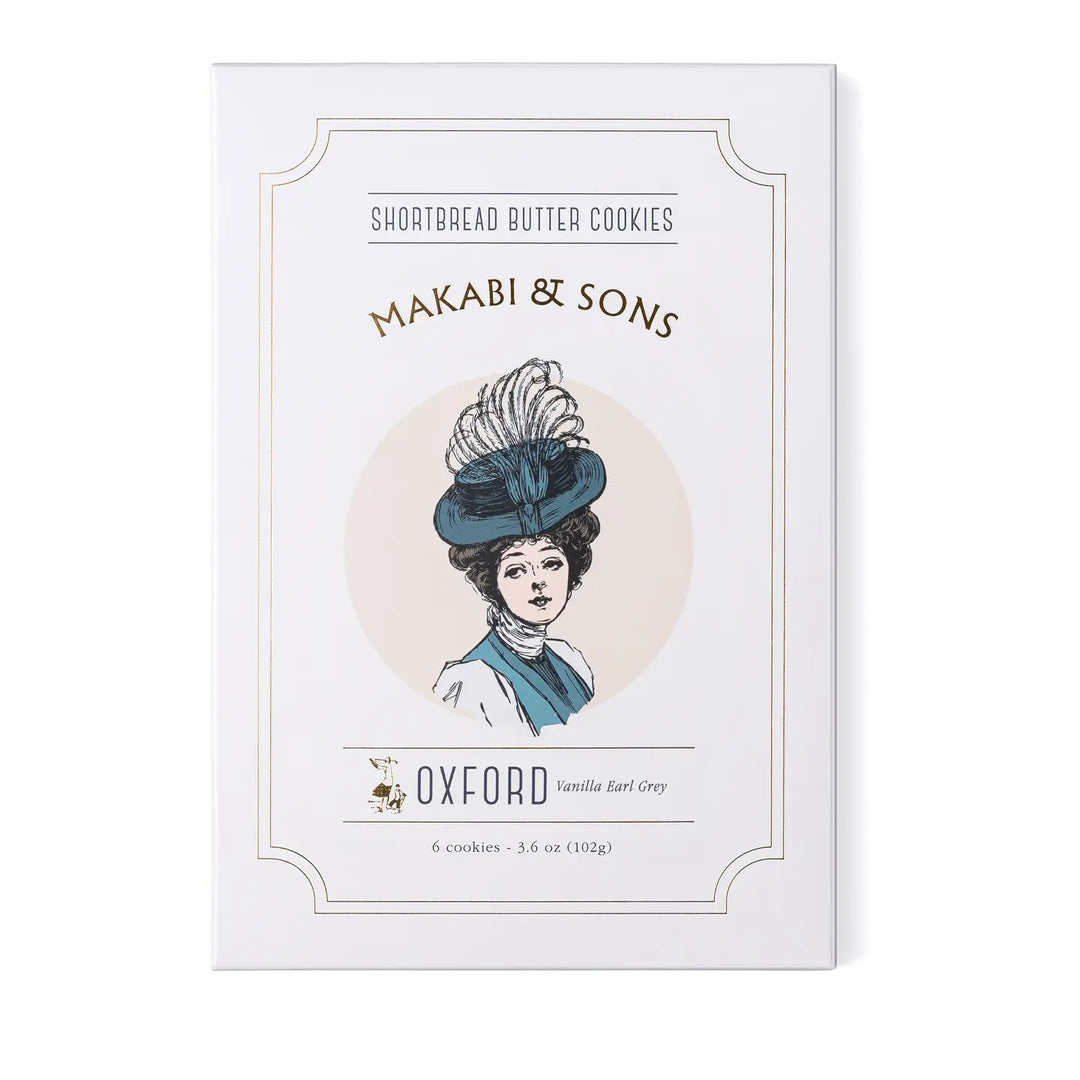 A box of Makabi & Sons Oxford Shortbread Butter Cookies, featuring an elegant vintage-style illustration of a woman in a feathered hat. The packaging highlights the vanilla and Earl Grey flavor of the cookies.