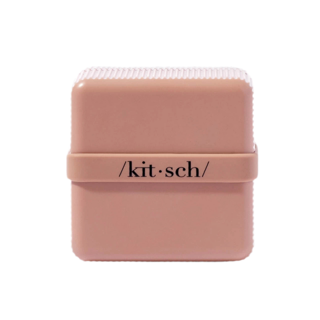 pink square box with the word kit-sch in black lettering