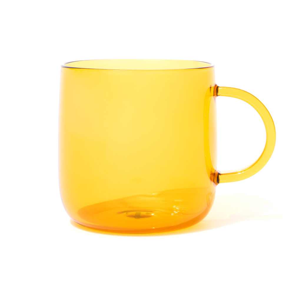 Yellow colored glass mug with a handle