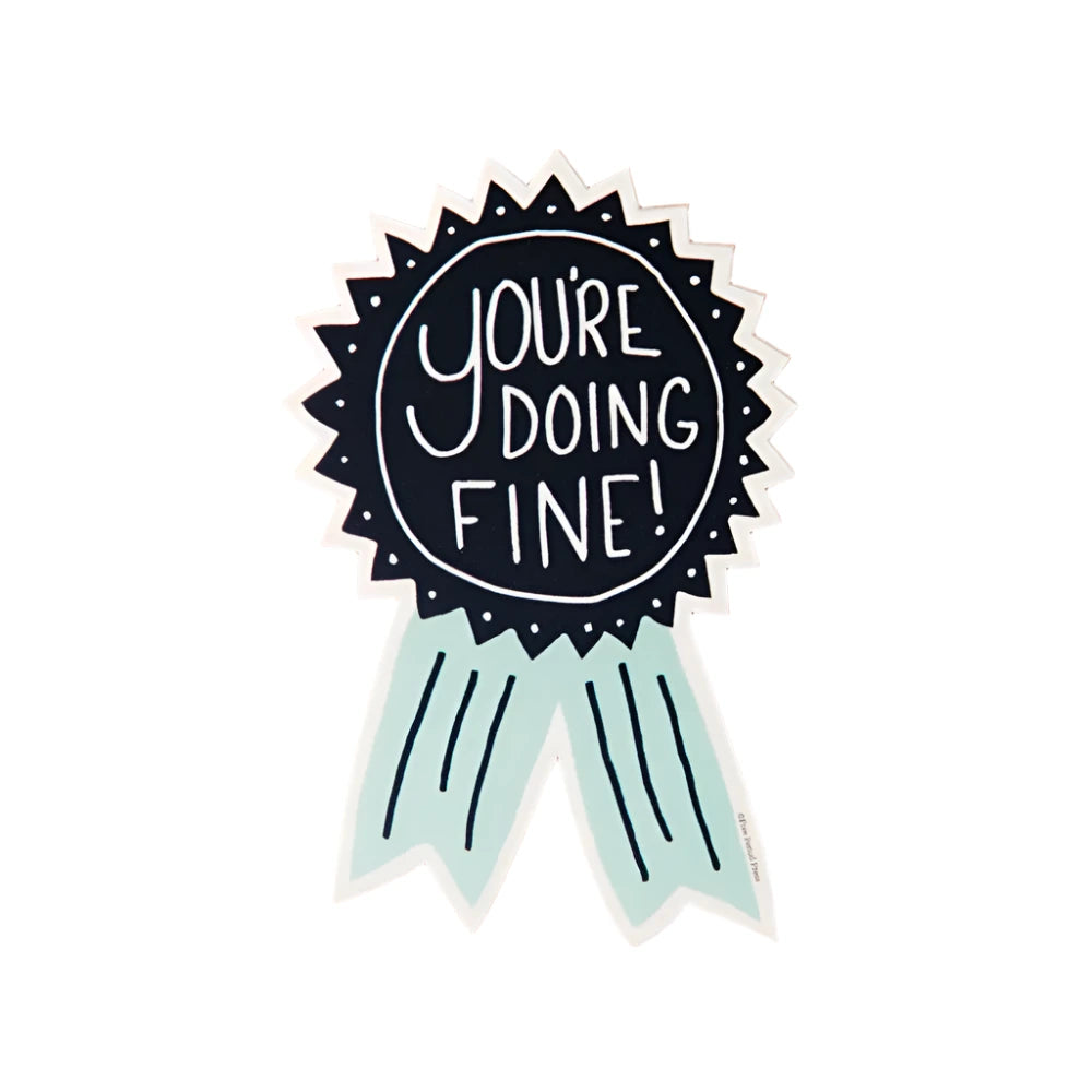 A sticker shaped like an award ribbon with the phrase "You're Doing Fine!" written in white on a black circular center, with mint green ribbon tails.