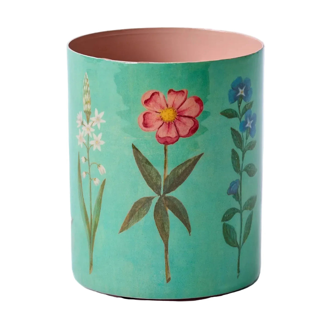 Teal enamel pot with pink, white, and blue floral illustrations and a pink interior.
