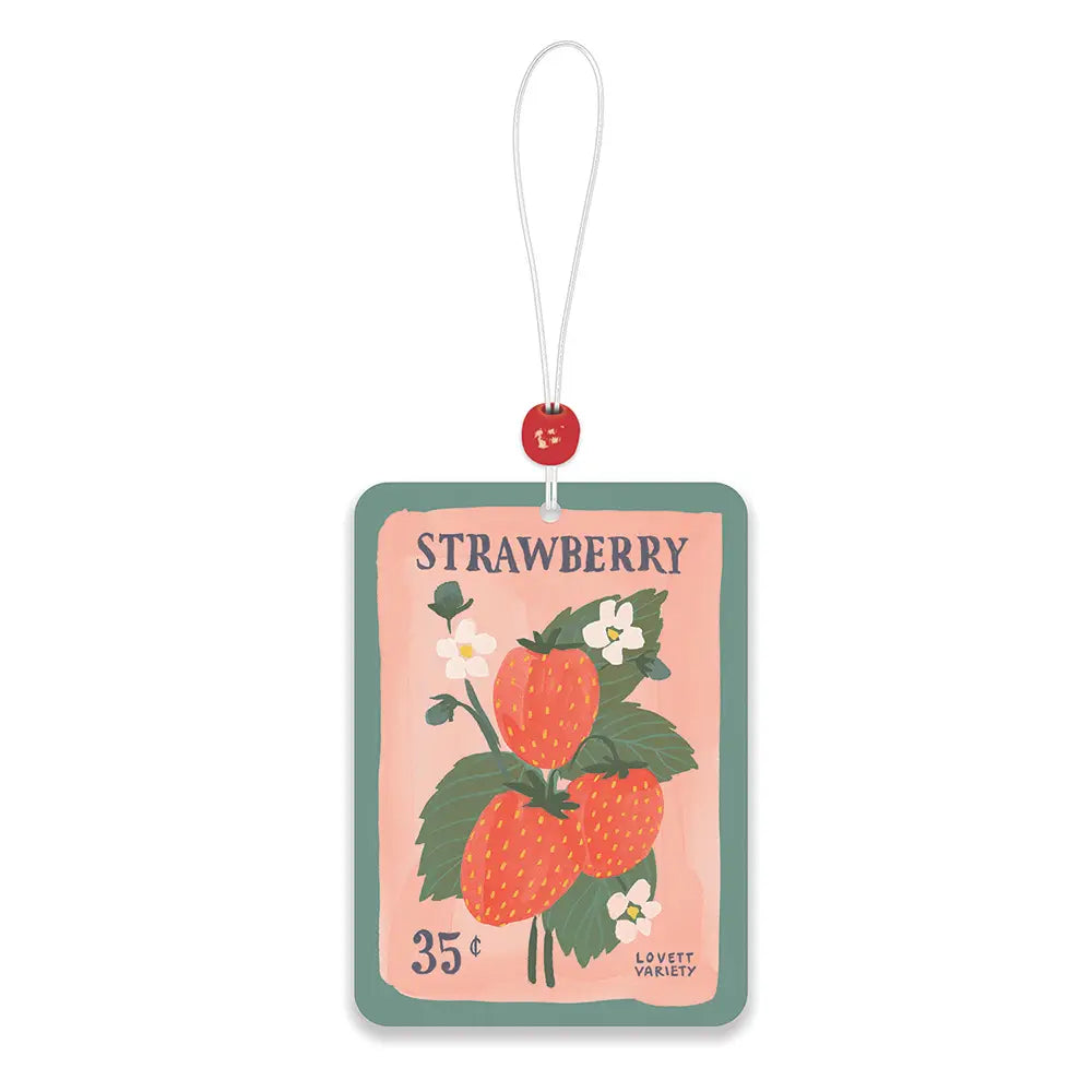 Rectangular car air freshener with illustrated strawberries, green leaves, and small white flowers on a vintage style seed packet design, hanging from a white string with a red bead.