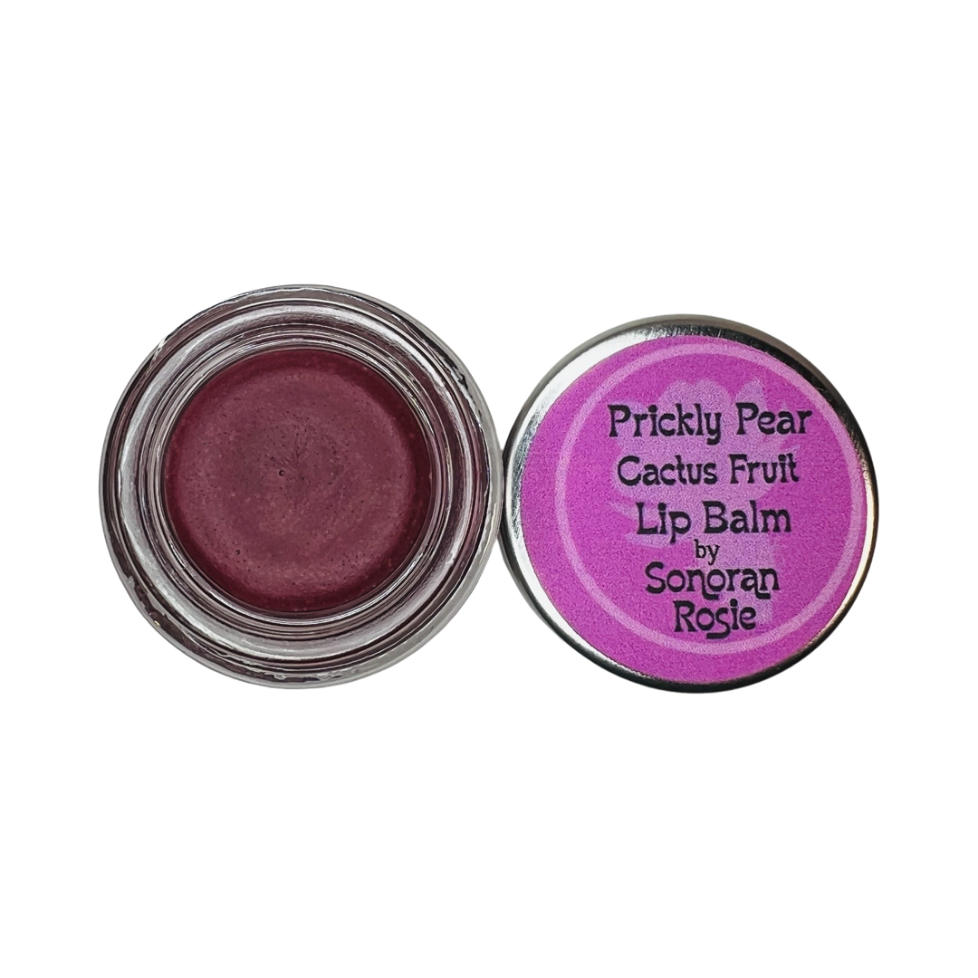 small round glass jar of a maroon lip balm with the lid right by it featuring a fuschia branded label