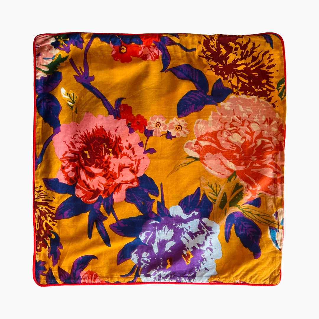 Mustard square pillow cover with a floral design.