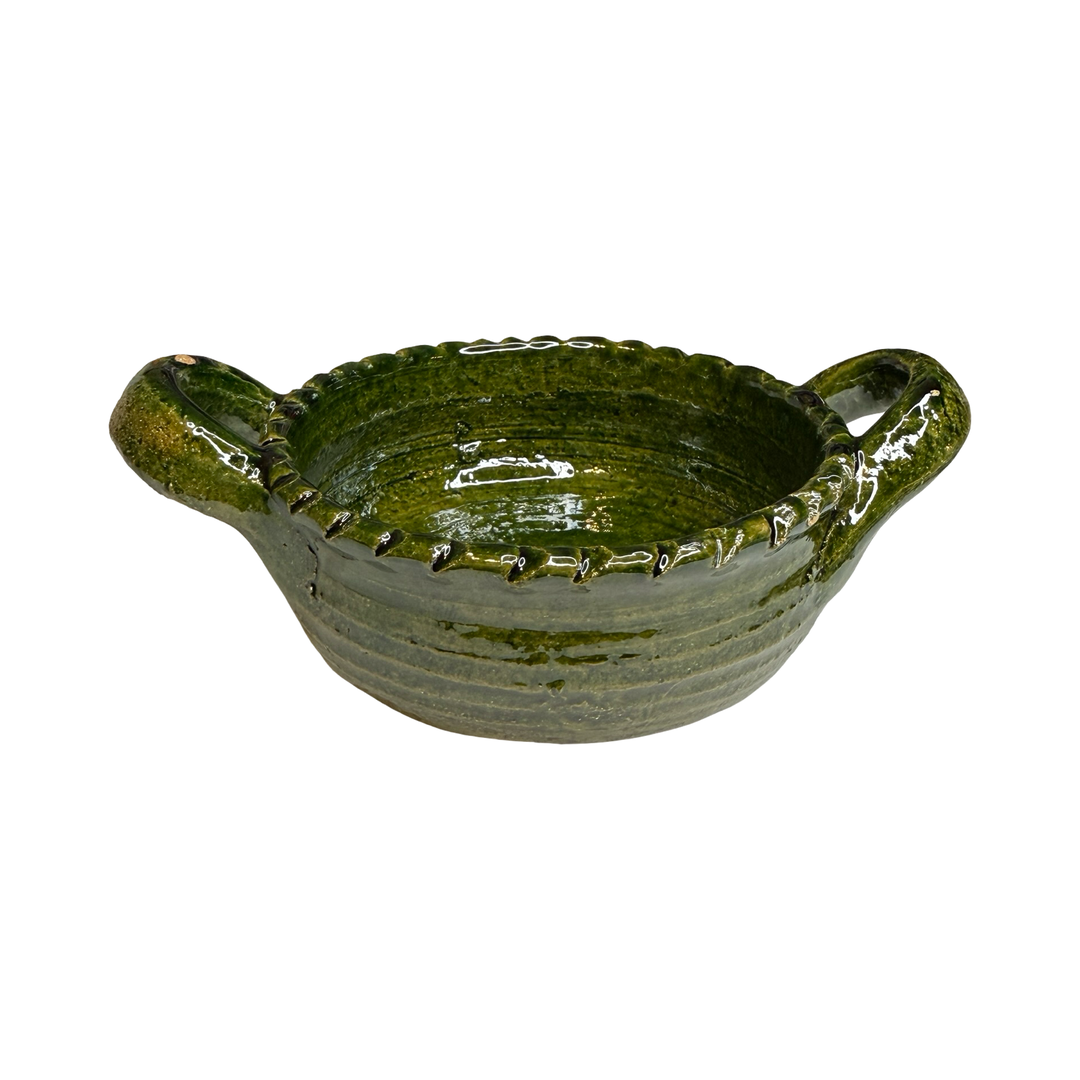 small round dish with handles featuring a green glaze.
