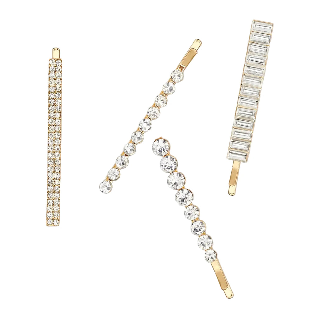Four gold metal bobby pins with assorted rhinestone designs.