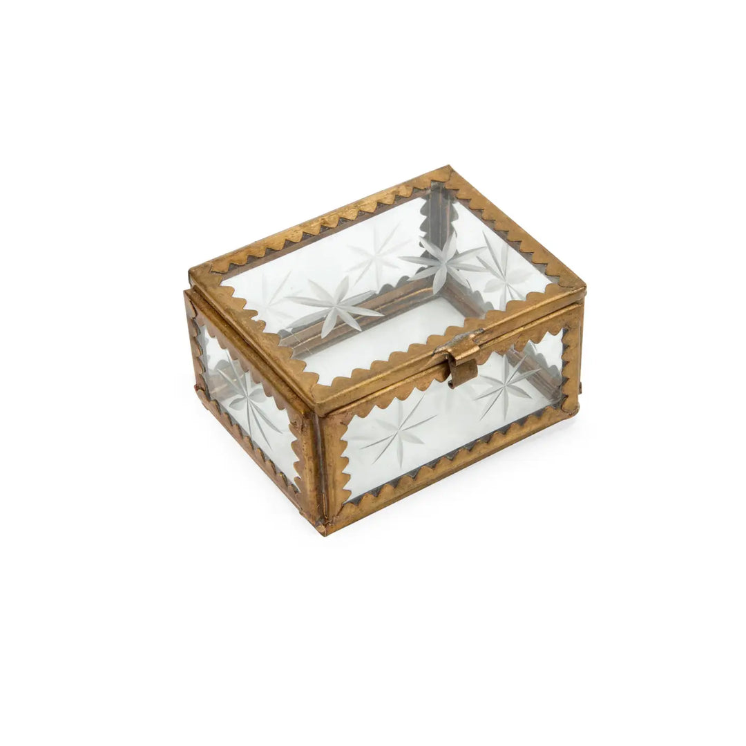 A small, rectangular trinket box with an antique brass frame and clear glass panels featuring etched starburst designs. The box has a hinged lid with a delicate latch, and its scalloped brass edges enhance its vintage-inspired charm.