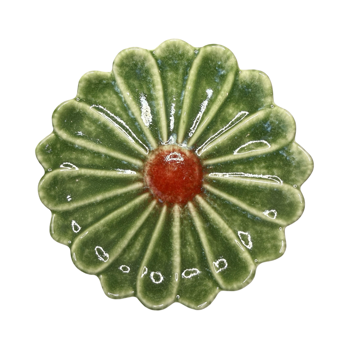 Stoneware flower-shaped dish in dark green with a red center glaze