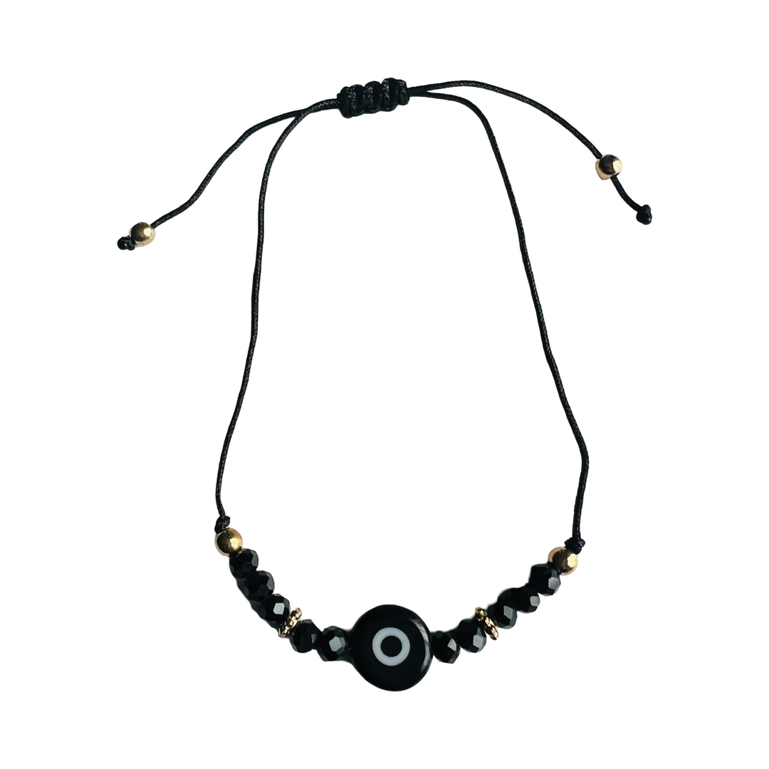 Black bead bracelet with a black evil eye charm and gold beads