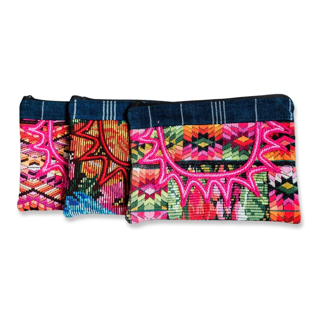 a trio of huipili designed cosmetic bags