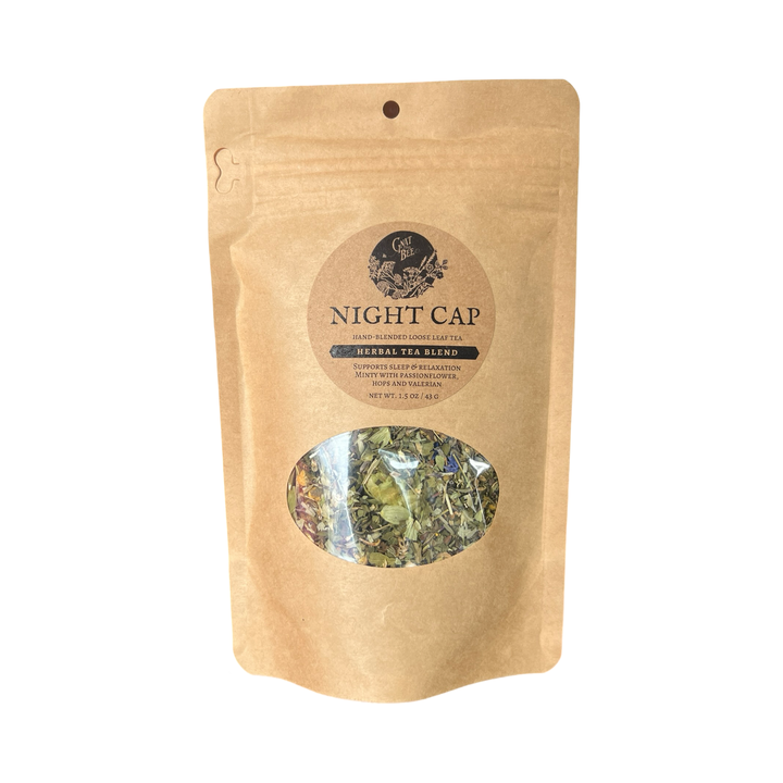 2 oz kraft pouch of Night Cap tea with a branded label and a clear window that displays the dried herbs and flowers that makes the tea.