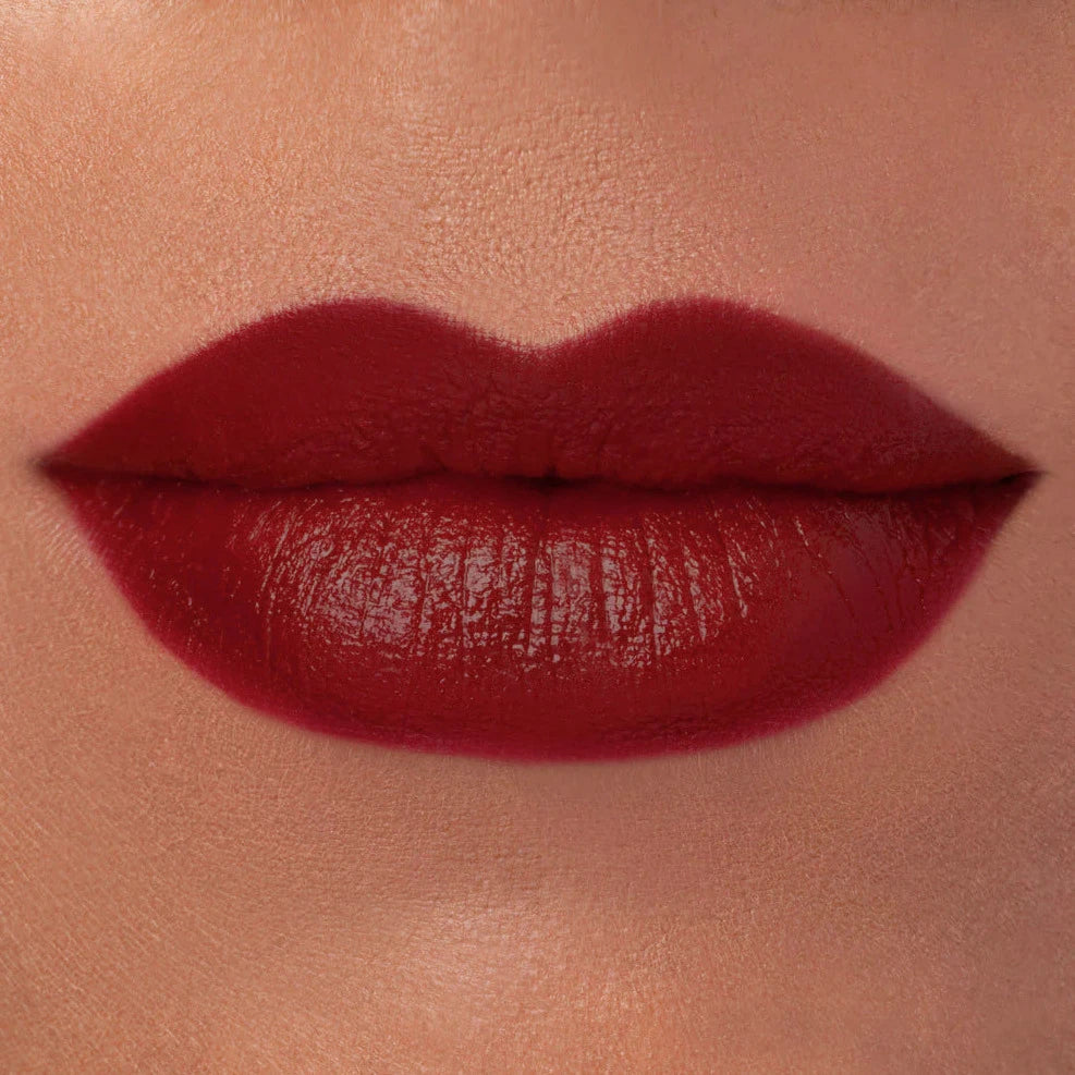 close up view of a pair of lips wearing red lipstick. Brand: Rituel De Fille