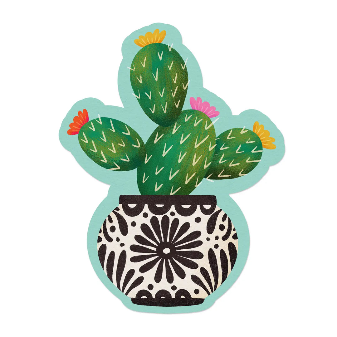 A die-cut sticker of a prickly pear cactus with colorful blooms, planted in a decorative black and white Mexican Talavera-style pot, set against a teal background.
