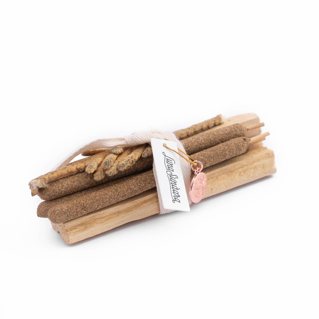 a bundle of palo santo sticks, palo santo incense and palma dulce tied with a linen tie and a branded tag.