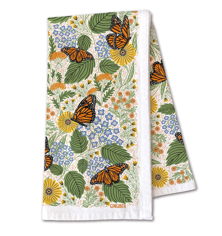 Colorful kitchen towel adorned with a botanical design of butterflies, flowers, and leaves in a lively garden-inspired pattern.