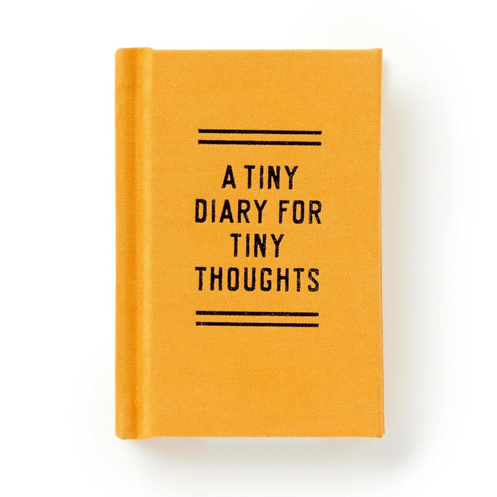 A small mustard yellow hardcover diary with bold black text reading A Tiny Diary for Tiny Thoughts.
