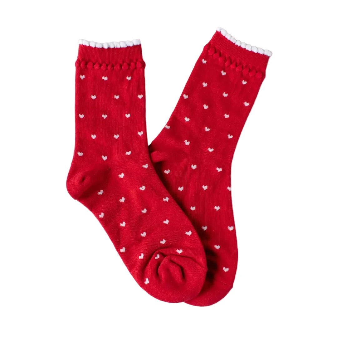 Pair of red socks with small white heart patterns and a scalloped top edge.