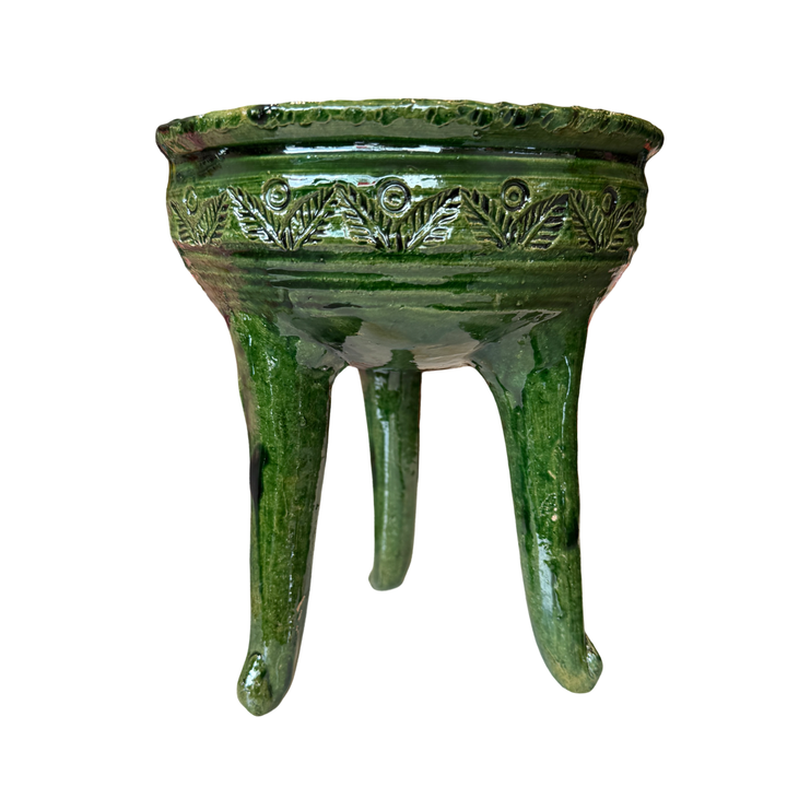 Green ceramic copalero with a stamped design.