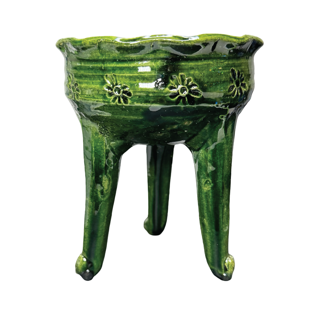 Green ceramic copalero with a stamped design.