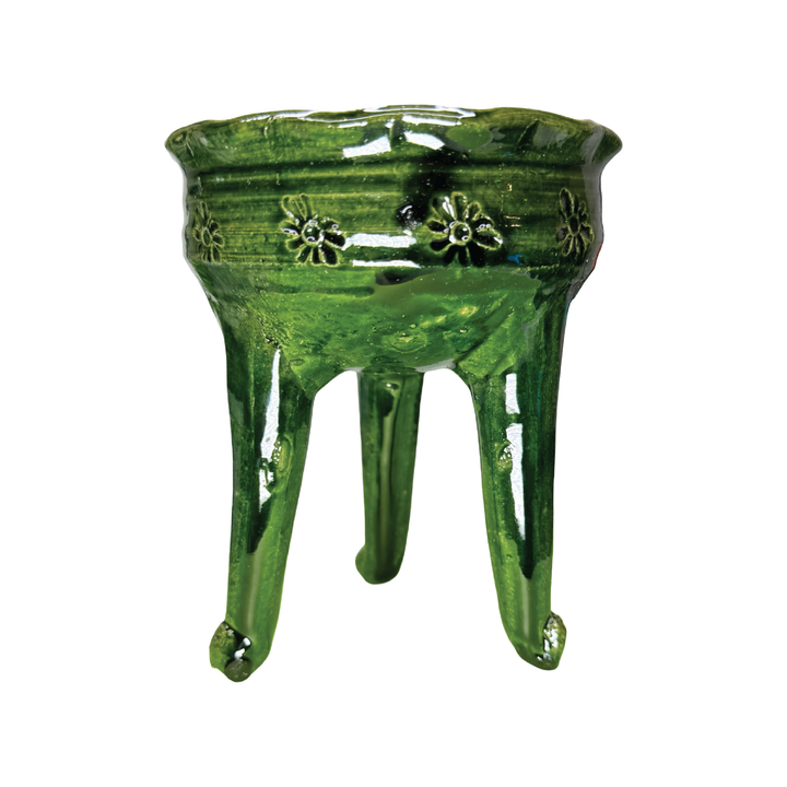 Green ceramic copalero with a stamped design.