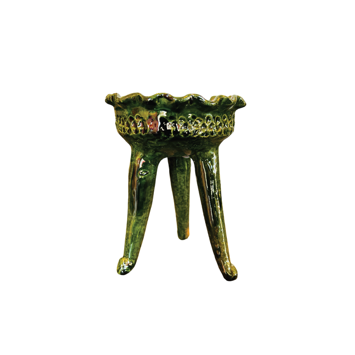 Green ceramic copalero with a stamped design.