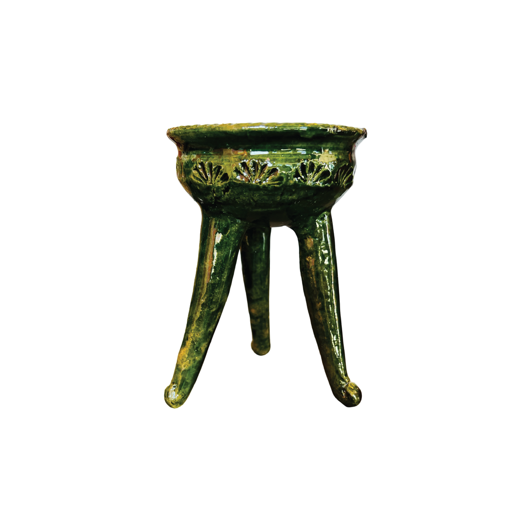 Green ceramic copalero with a stamped design.
