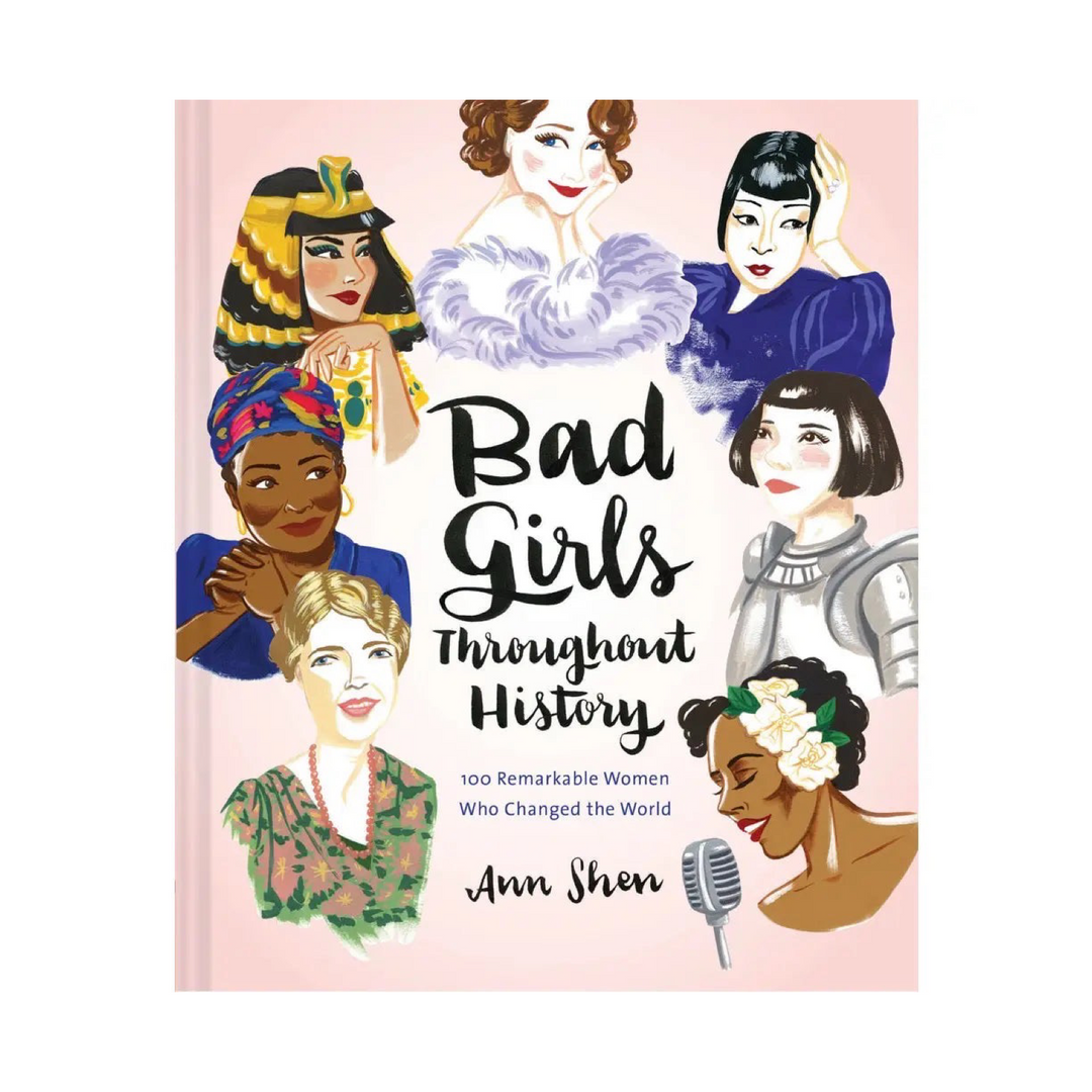 Book titled 'Bad Girls Throughout History: 100 Remarkable Women Who Changed the World' light pink cover features illustrated images of 7 historical icons surrounding the black cursive title text.
