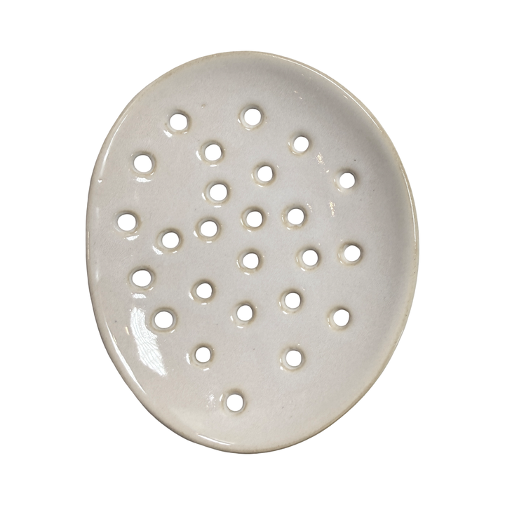 round ceramic footed soap dish with perforated drainage holes, shown in white.