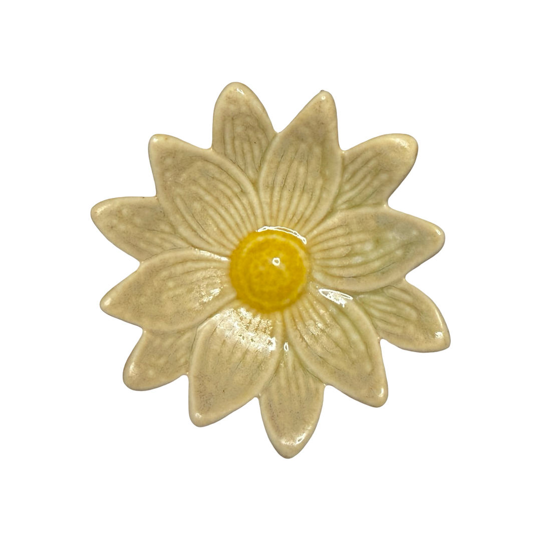 Stoneware daisy-shaped dish in beige with a yellow center glaze