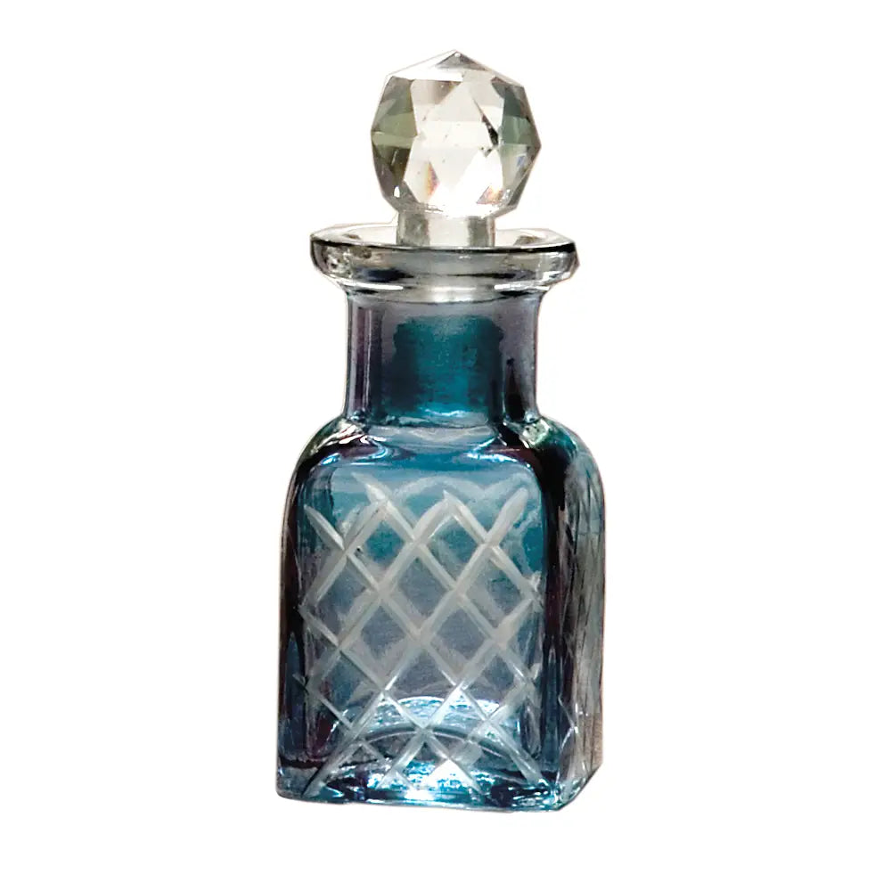 Blue glass perfume bottle with etched crisscross design, topped with a faceted crystal stopper.