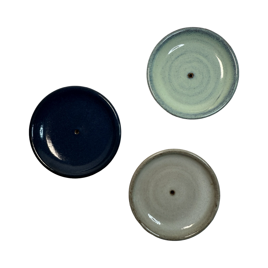 Trio of round ceramic incense holders: Gray, Light Blue and Deep Blue shown on a white background.