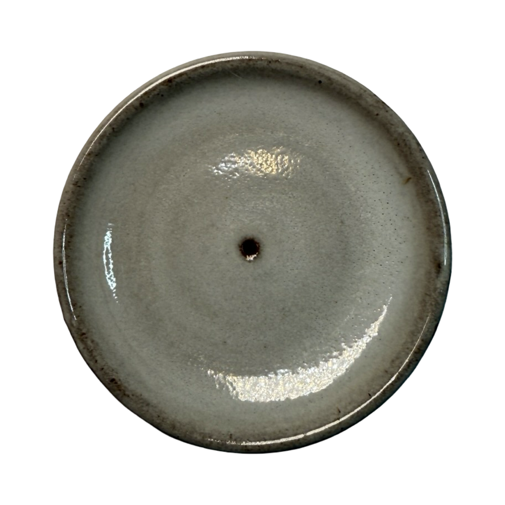 Gray ceramic round incense holder on a white background.