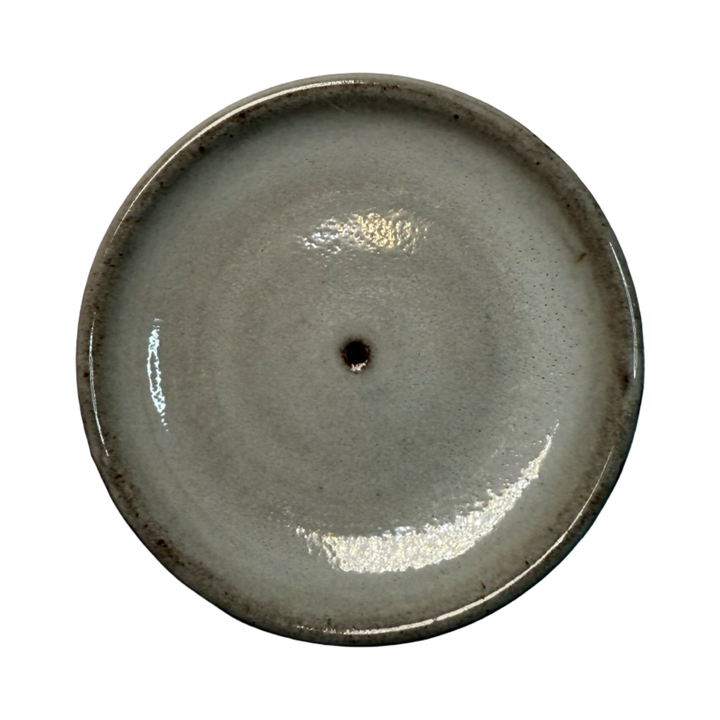 Gray ceramic round incense holder on a white background.