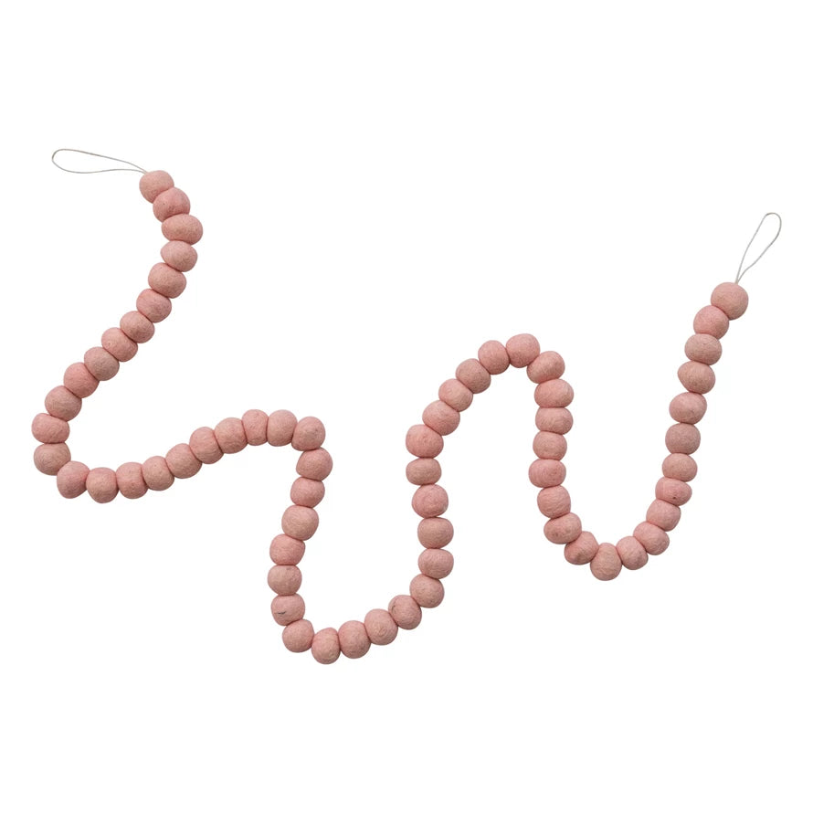 A string of light pink felt balls with loops to hang on each side. 