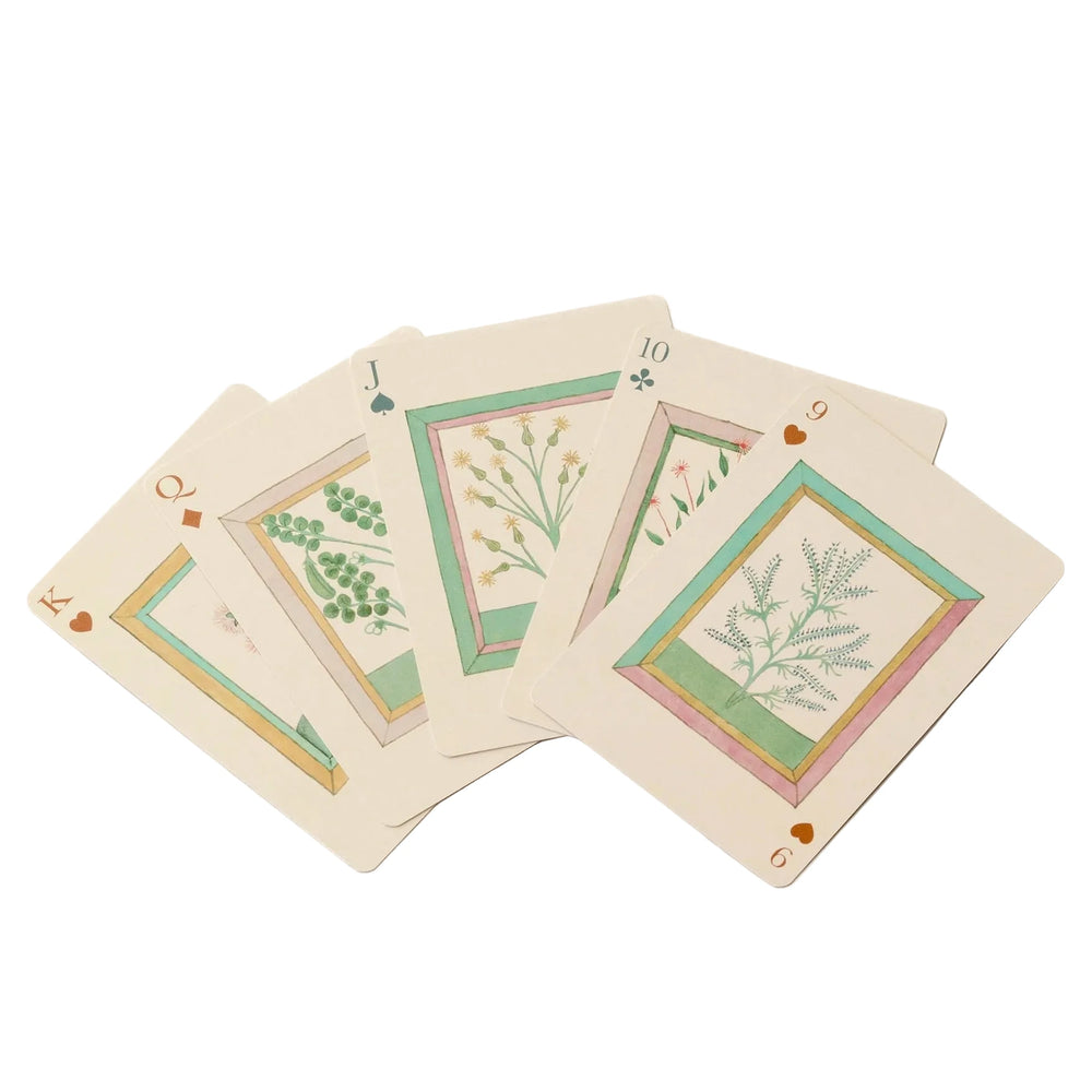 Set of playing cards with botanical designs on a white background