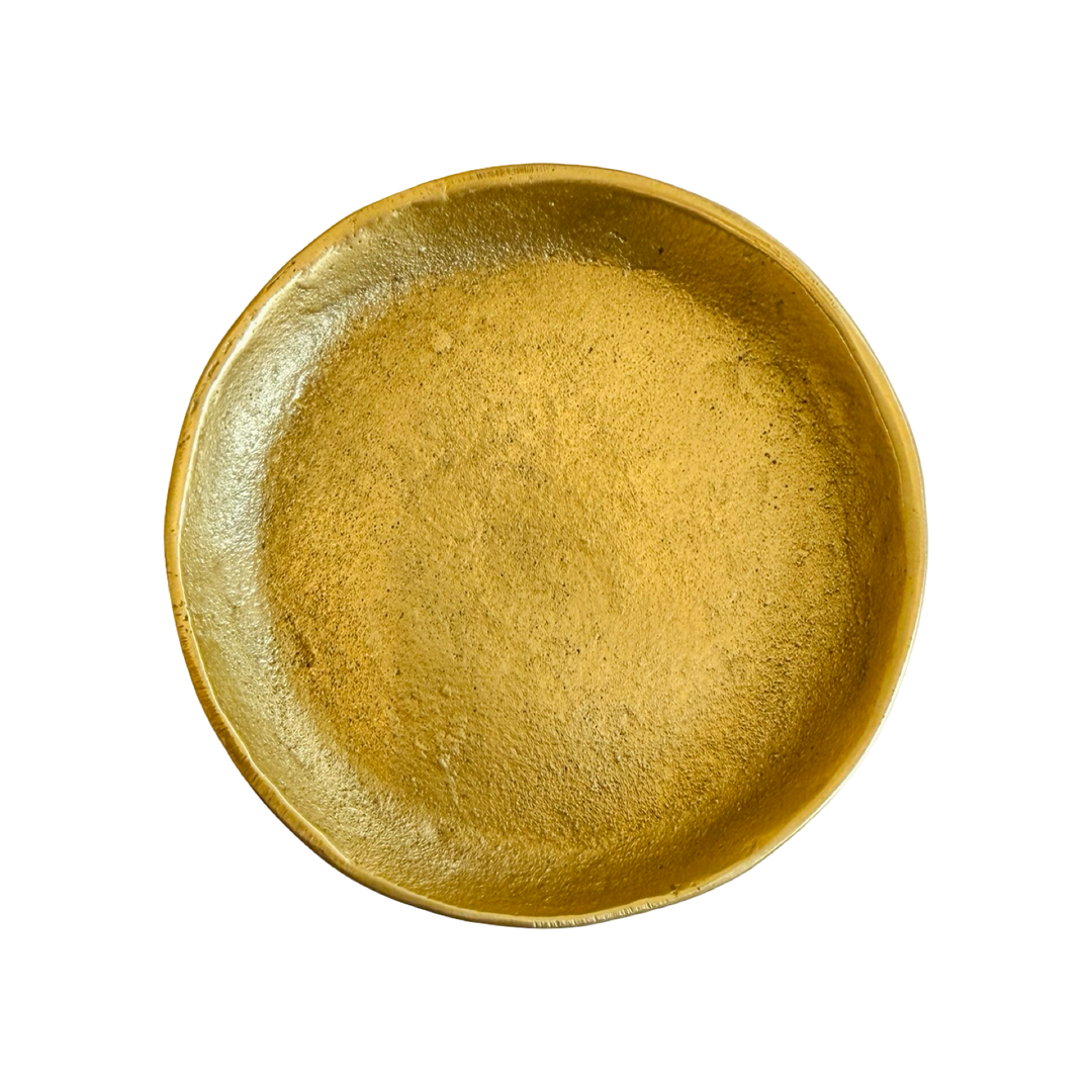 Round brass dish on a white background.