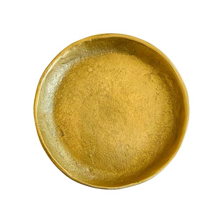 Round brass dish on a white background.