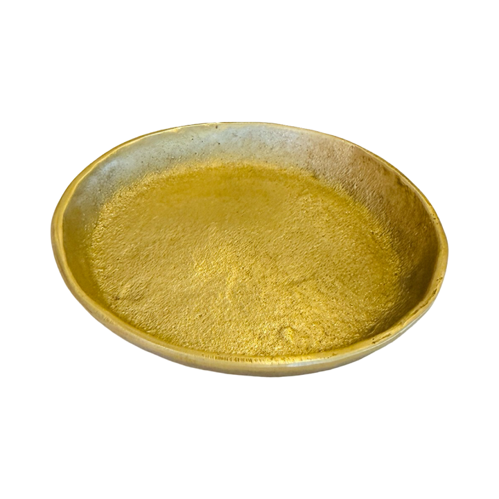 Angled view of a round brass dish.