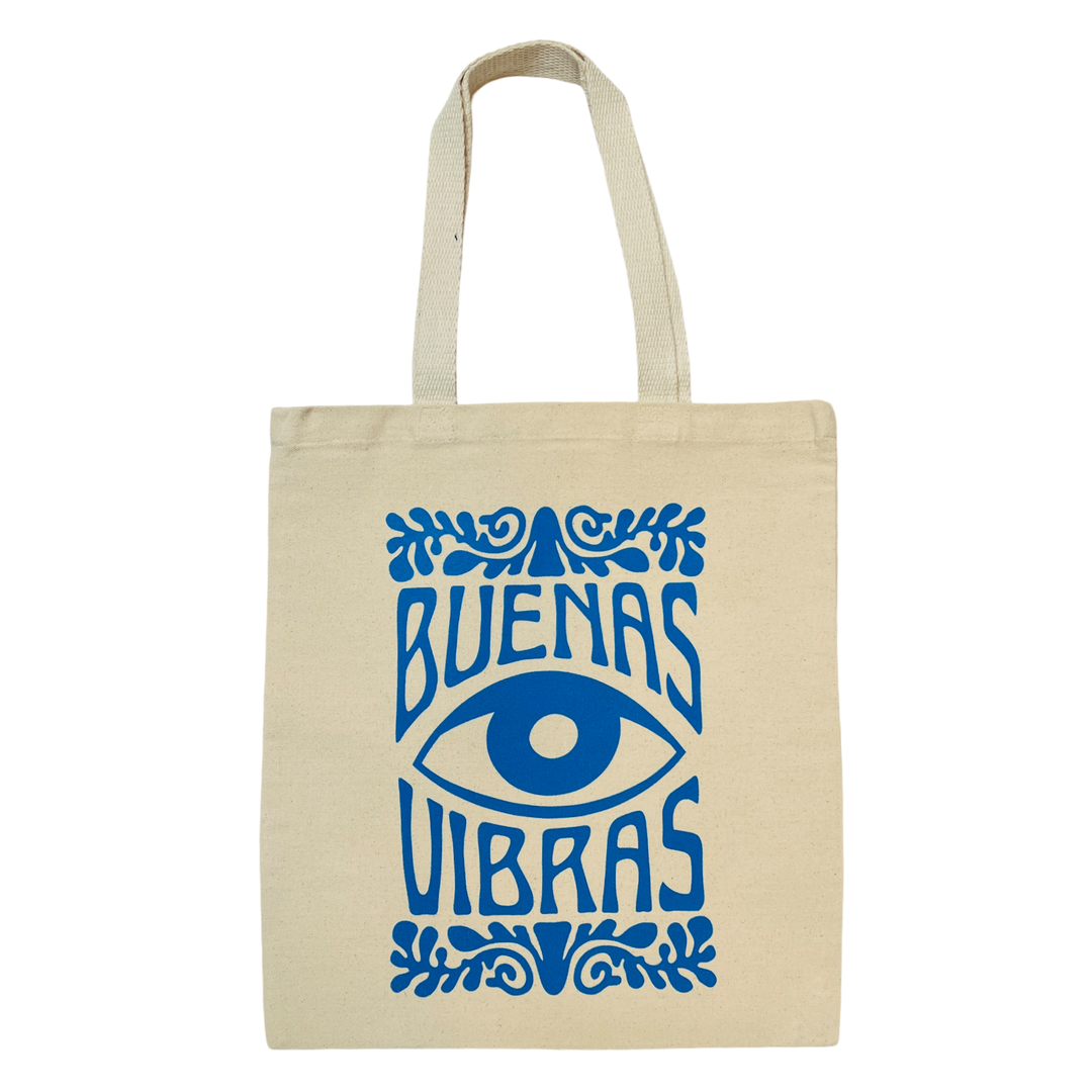 natural canvas tote bag with the image of an eye and the phrase Buenas Vibras all in the color blue