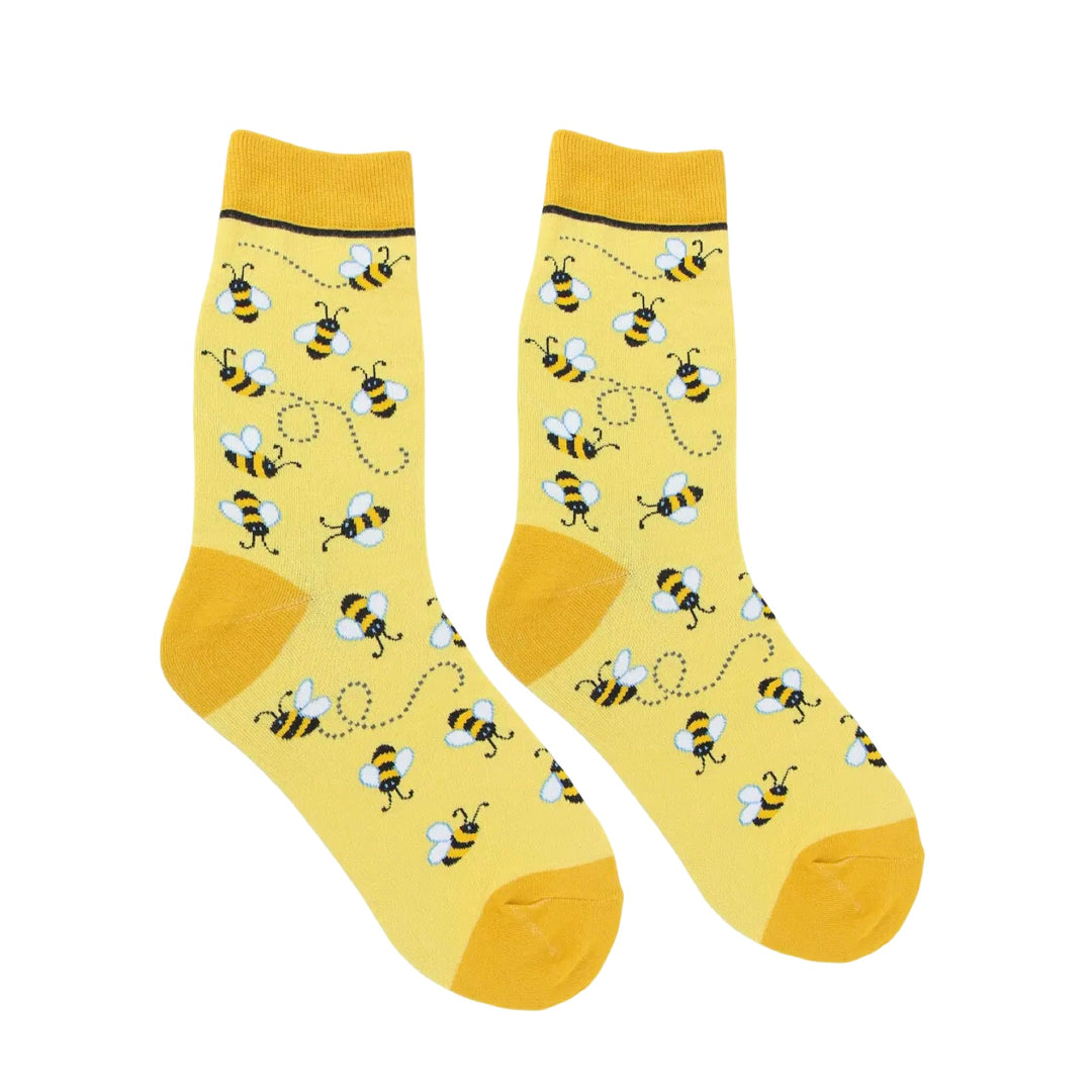 Pair of Yellow women’s sock with buzzing black and gold bumble bee patterns and dotted flight trails.