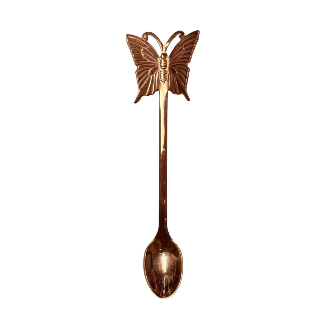 Bronze spoon with a butterfly on the end.