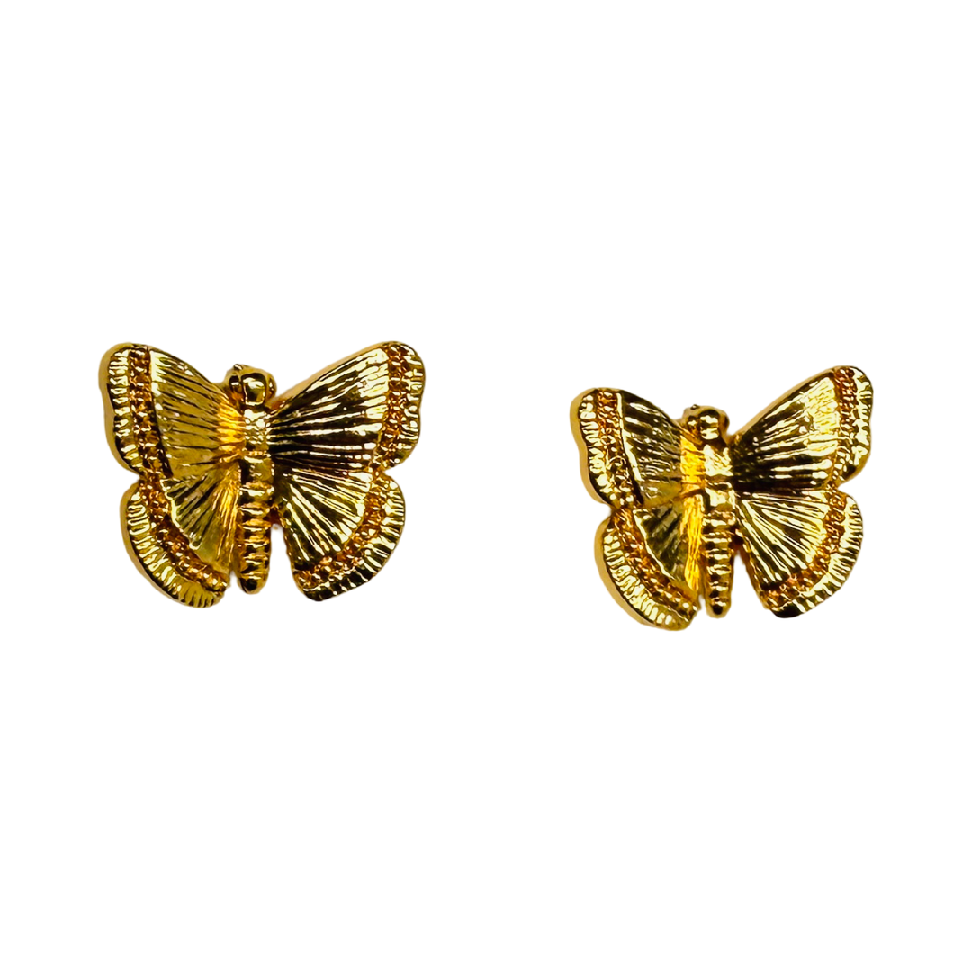 Gold butterfly earrings on a white background