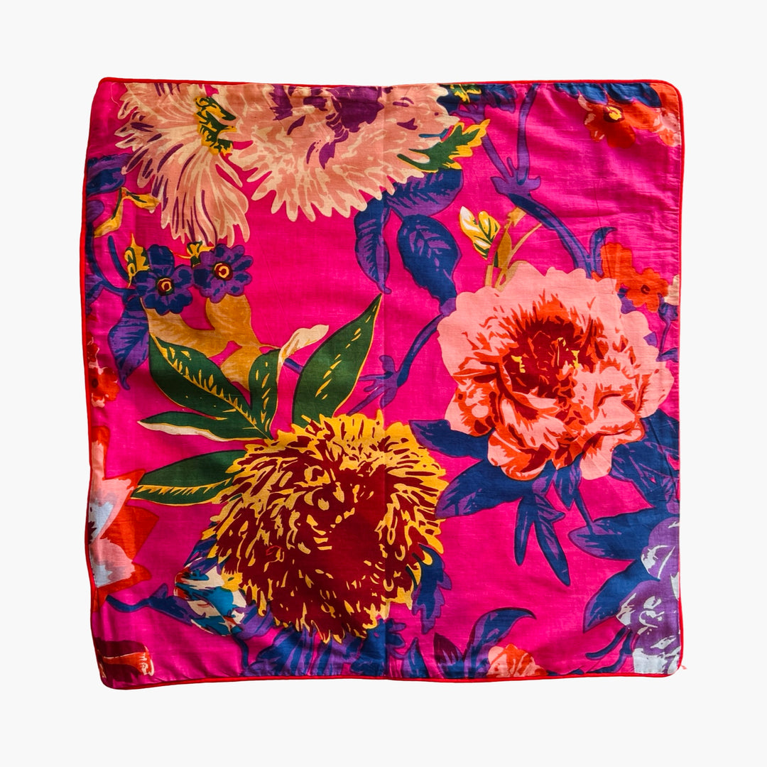 Hot pink square pillow cover with a floral design.