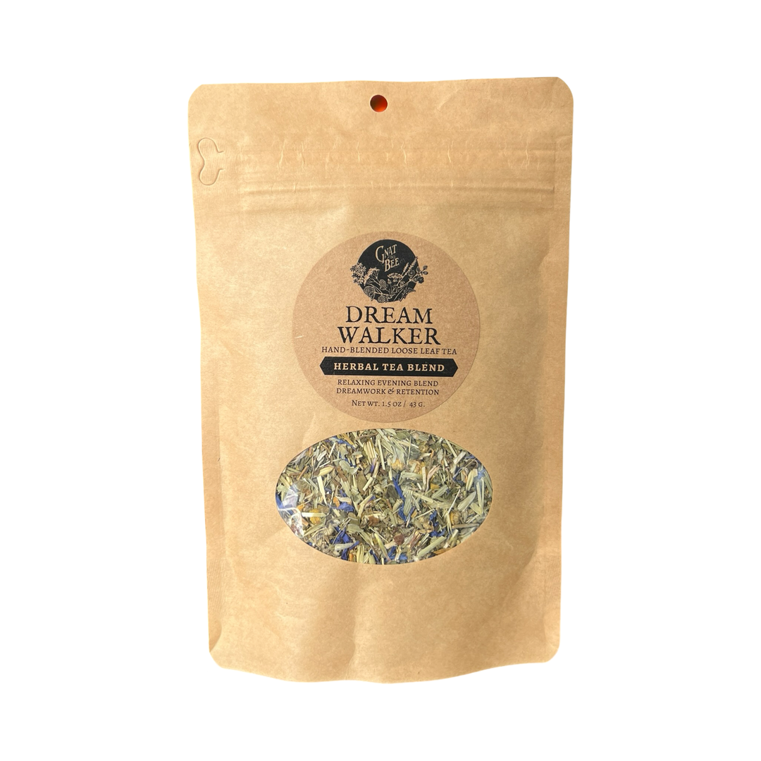 2 oz kraft pouch of Dream Walker tea with a branded label and a clear window that displays the dried herbs and flowers that makes the tea.