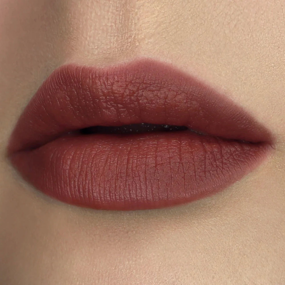close up view of a pair of lips wearing a rose colored lipstick. Brand: Rituel De Fille