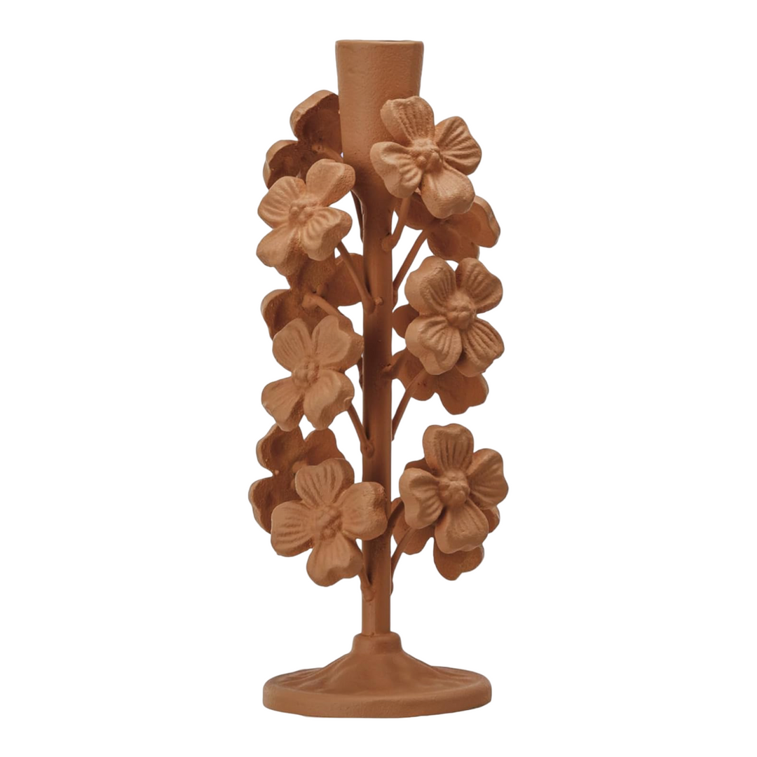 Apricot-colored taper candle holder with raised floral detailing and a matte finish.